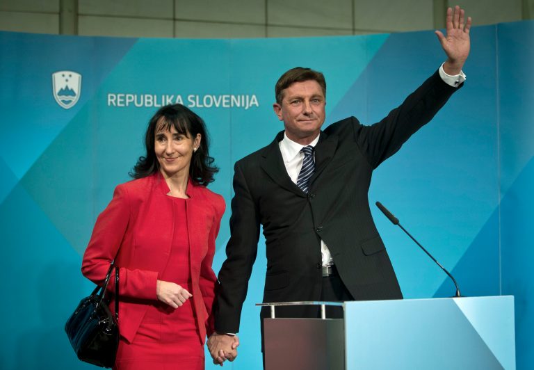   President elect, Slovenia's former prime minister Borut Pahor, right, with his spouse Tanja Pecar waves to the media in Ljubljana, Slovenia, Sunday, Dec. 2, 2012. Pahor, who has called for unity in the tiny EU nation amid growing discontent with government tax hikes and spending cuts, won the presidential election. (AP Photo/Darko Bandic)  