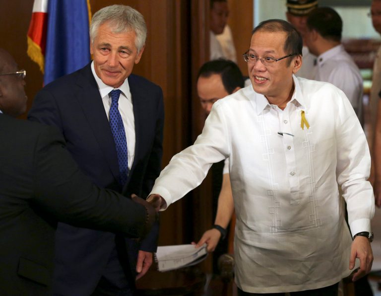Philippine President Benigno Aquino III, right, shakes hands beside U.S. Defense Secretary Chuck Hagel, center, during his visit at the Malacanang Presidential Palace in Manila, Philippines on Friday, Aug. 30, 2013. Hagel said Friday the Obama administration was consulting with allies to 