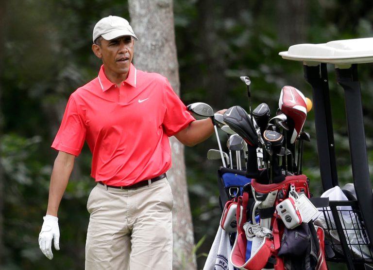 President Obama selects a club while golfing at Farm Neck Golf Club, in Oak Bluffs, Mass., on the island of Martha's Vineyard on Aug. 23. (AP/Steven Senne)