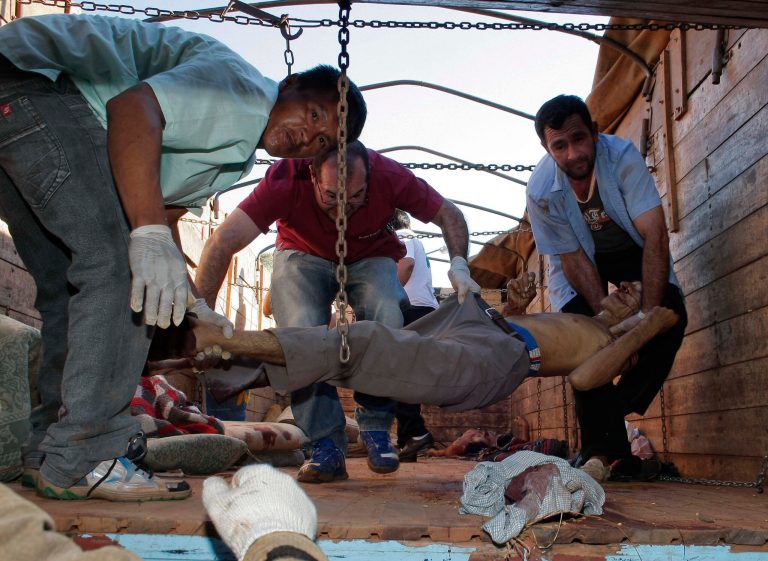   The body of a farmer killed during a land eviction, is carried off a truck in Curuguaty, Paraguay, Friday, June 15, 2012. Paraguay deployed its army on Friday to resolve the violent land dispute in Curuguaty, a remote northern forest reserve, where 17 people have been killed in gun battles between police and landless farmers when police were trying to evict about 150 farmers from the reserve, which is part of a huge estate owned by a Colorado Party politician opposed to leftist President Fernando Lugo. (AP Photo)  