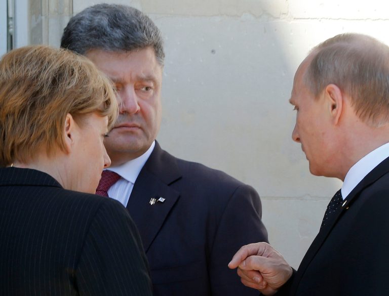 German Chancellor Angela Merkel, left, Russian President Vladimir Putin, right, and Ukrainian president-elect Petro Poroshenko, center, talk after a group photo before a luncheon as they take part in the 70th anniversary of D-Day in Benouville in Normandy, France, Friday, June 6, 2014. (AP Photo/Charles Dharapak)