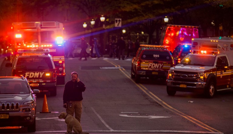 Police stand guard near the scene after a motorist drove onto a busy bicycle path near the World Trade Center memorial and struck several people. (AP Photo/Andres Kudacki)
