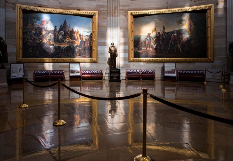   Normally filled with visitors and tourists, the empty Rotunda at the U.S. Capitol is seen in Washington, Tuesday, Oct. 1, 2013, after officials suspended all organized tours of the Capitol and the Capitol Visitors Center as part of the government shutdown. A statue of President Gerald R. Ford at center is illuminated amid large paintings illustrating the history of the United States. (AP Photo/J. Scott Applewhite)  