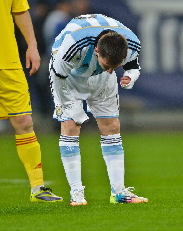 FILE - In this March 5, 2014 file photo, Argentina's Lionel Messi appears to vomit during an international friendly soccer game against Romania on the National Arena stadium in Bucharest, Romania. Messi has vomited at least a half-dozen times with Argentina and club team Barcelona, mystifying doctors and fans alike. (AP Photo, File) ROMANIA OUT