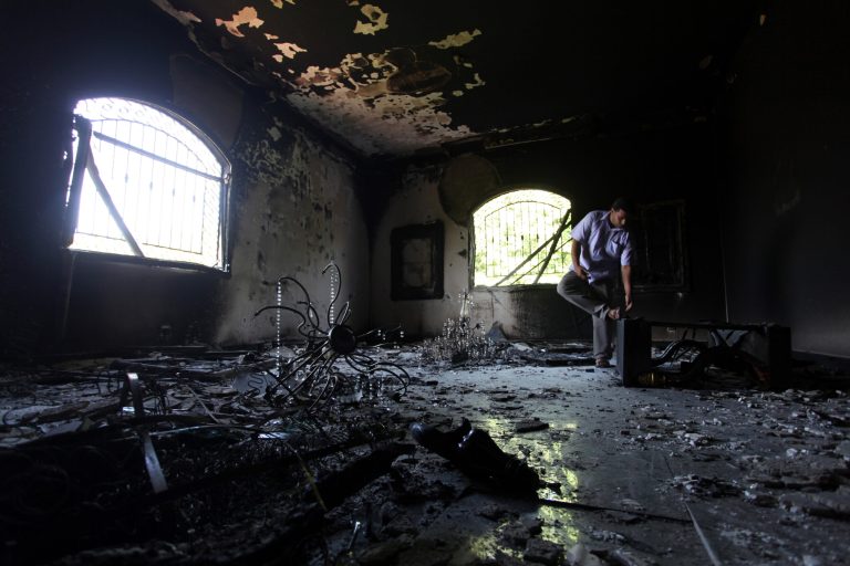 A Libyan man investigates the inside of the U.S. Consulate after an attack that killed four Americans, including Ambassador Chris Stevens, on the night of Tuesday, Sept. 11, 2012, in Benghazi, Libya. (AP Photo/Mohammad Hannon)