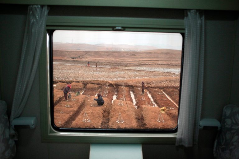   In this photo taken on Sunday, April 8, 2012, North Koreans work in a field seen from a passing train on the outskirts of Pyongyang, North Korea. The United Nations has called for $198 million in donations for 2012 - mostly to help feed the hungry but also to invest in programs designed to prevent the chronic deprivation that has led to persistent malnutrition among North Korea's young. (AP Photo/Ng Han Guan)  