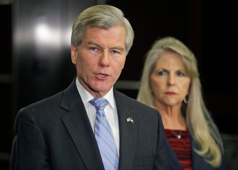 Former Virginia Gov. Bob McDonnell makes a statement as his wife, Maureen, listens during a news conference in Richmond, Va., Tuesday, Jan. 21, 2014.  McDonnell and his wife were indicted Tuesday on corruption charges after a monthslong federal investigation into gifts the Republican received from a political donor.  (AP Photo/Steve Helber)