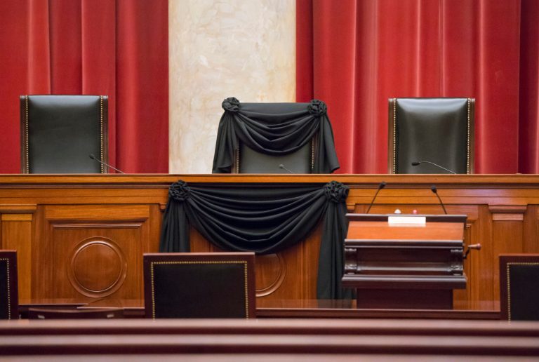 Supreme Court Justice Antonin Scalia's courtroom chair is draped in black to mark his death as part of a tradition that dates to the 19th century, Tuesday, Feb. 16, 2016, at the Supreme Court in Washington. Scalia died Saturday at age 79. He joined the court in 1986 and was its longest-serving justice. (AP Photo/J. Scott Applewhite)