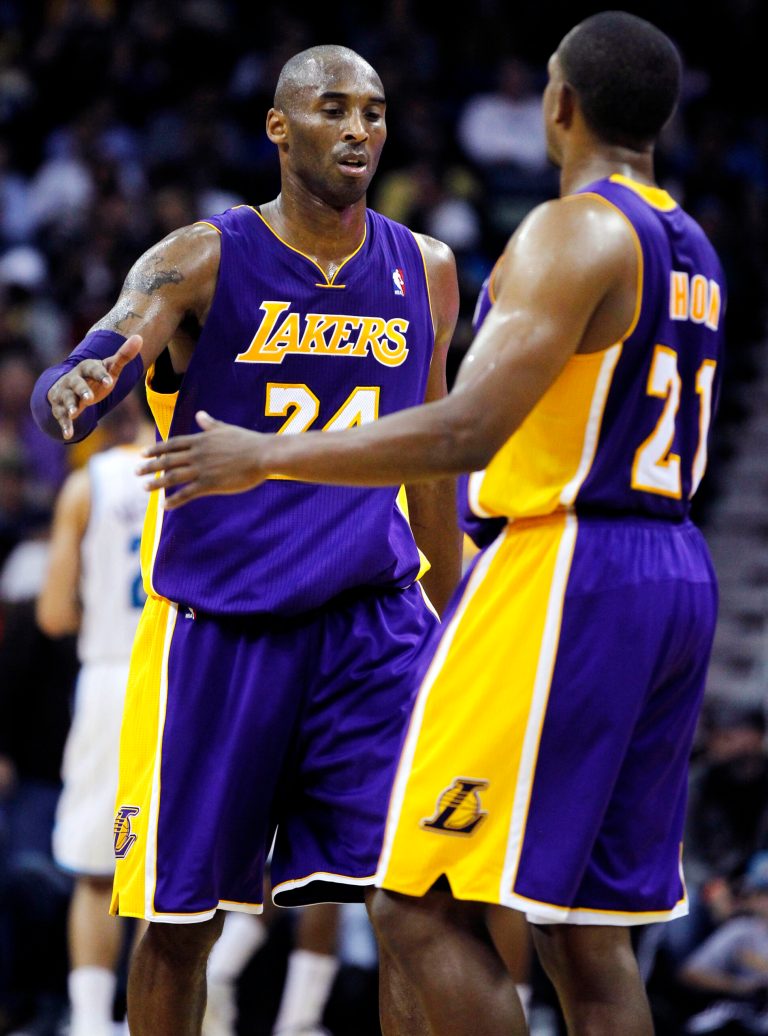  Los Angeles Lakers shooting guard Kobe Bryant (24) is greeted by point guard Chris Duhon (21) at the end of the first half of an NBA basketball game against the New Orleans Hornets in New Orleans, Wednesday, Dec. 5, 2012. Bryant became the youngest player in NBA history to break 30,000 points during the half. (AP Photo/Gerald Herbert)  