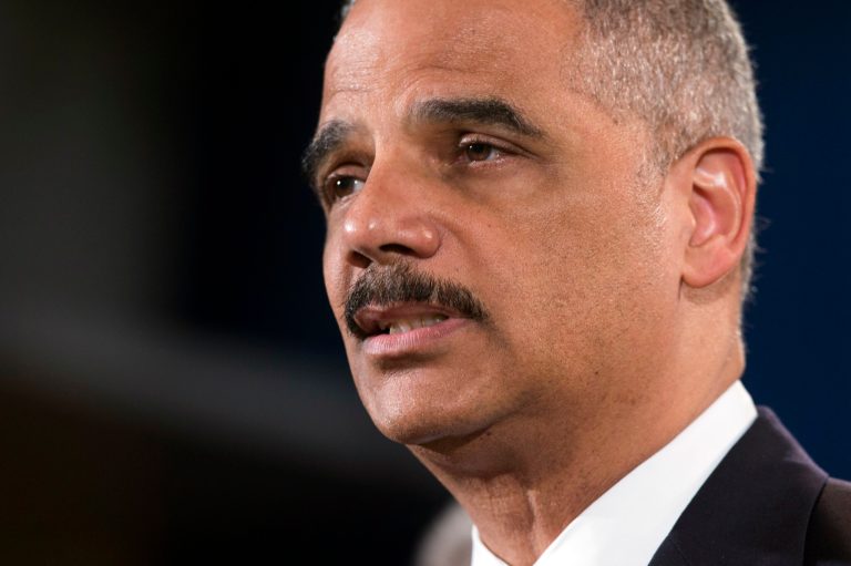 Attorney General Eric Holder speaks during a news conference at the Justice Department, on Monday, May 19, 2014, in Washington. The Justice Department on Monday charged Credit Suisse AG with helping wealthy Americans avoid paying taxes through offshore accounts, and a person familiar with the matter said the European bank has agreed to pay about $2.6 billion in penalties. (AP Photo/ Evan Vucci)