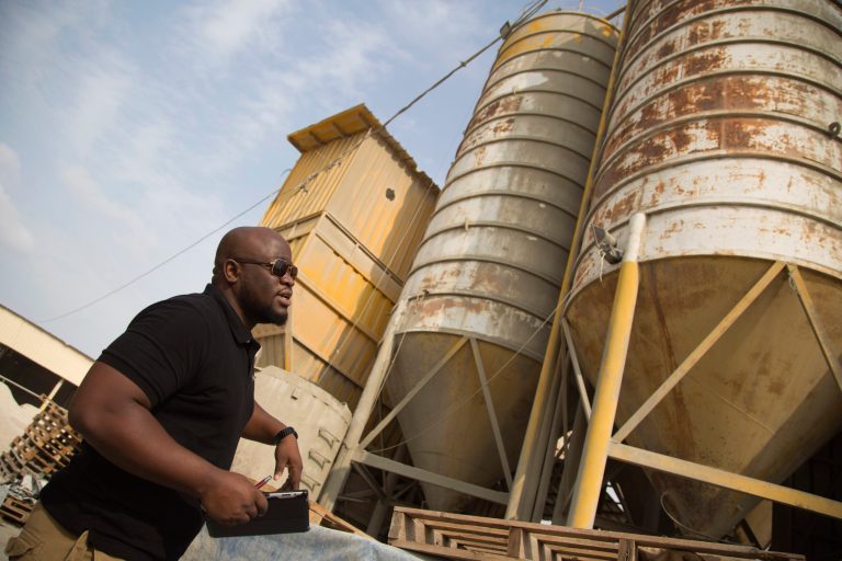 Keith Mathias-O'Chez, an inspector of building materials for the U.N. Relief and Works Agency, visits one of seven mixing concrete factories that are responsible for preparing the concrete for the U.N. projects in the Gaza Strip, Saturday, Oct. 11, 2014. After the Gaza war, the U.N. brokered a deal with Israel and the Palestinian government under which Israel is to allow imports of construction materials for the private sector. On the Gaza side, the shipments are to be tracked by U.N. and Palestinian officials. (AP Photo/Khalil Hamra)
