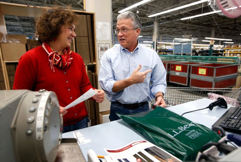   LL Bean CEO Chris McCormack, right, and company spokesman Carolyn Beem prepare packages for shipping at the company's order fulfillment center, Thursday, Dec. 20, 2012, in Freeport, Maine. At this time of the year the company's white-collar executives have abandoned their desks in favor of the shipping department at L.L. Bean, part of a final push to get things shipped in time for Christmas. (AP Photo/Robert F. Bukaty)  
