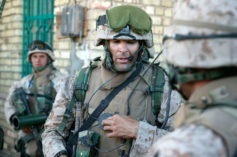 Then-Capt. Doug Zembiec gives orders to his men over a radio prior to leaving their secured compound for a short patrol in Fallujah, Iraq, in 2004. (AP/U.S. Marine Corps. via The Albuquerque Journal, Sgt. Jose E. Guillen)