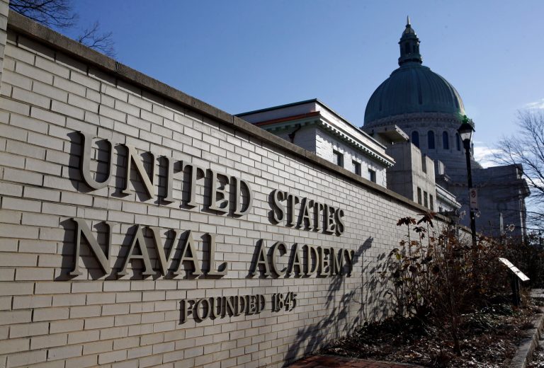 A sign stands outside of an entrance to the U.S. Naval Academy campus in Annapolis, Md., Thursday, Jan. 9, 2014. A culture of bad behavior and disrespect among athletes at U.S. military academies is one part of the continuing problem of sexual assaults at the schools, according to a new Defense Department report that comes in the wake of scandals that rocked teams at all three academies last year. (AP Photo/Patrick Semansky)
