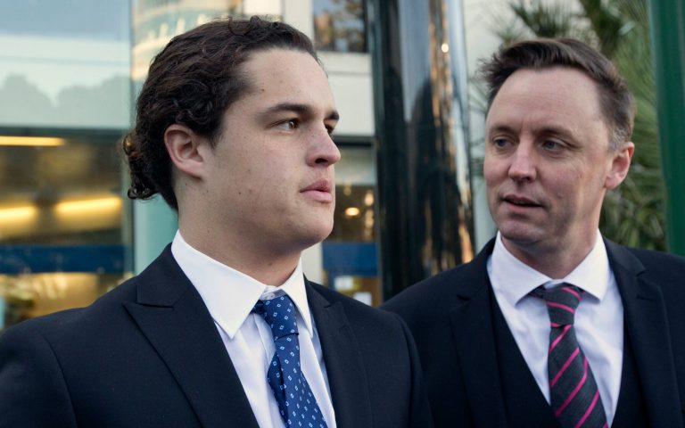 In this Monday, June 23, 2014 photo, sixteen-year-old Lucan Battison, left, with his lawyer, Jol Bates, arrives at the High Court in Wellington, New Zealand, where Battison is fighting his suspension from his Catholic high school because of his long hair. In a decision released Friday, June 27, 2014, New Zealand High Court judge David Collins found that both Battison's suspension and the school's hair rules were unlawful. (AP Photo/New Zealand Herald, Mark Mitchell) NEW ZEALAND OUT, AUSTRALIA OUT