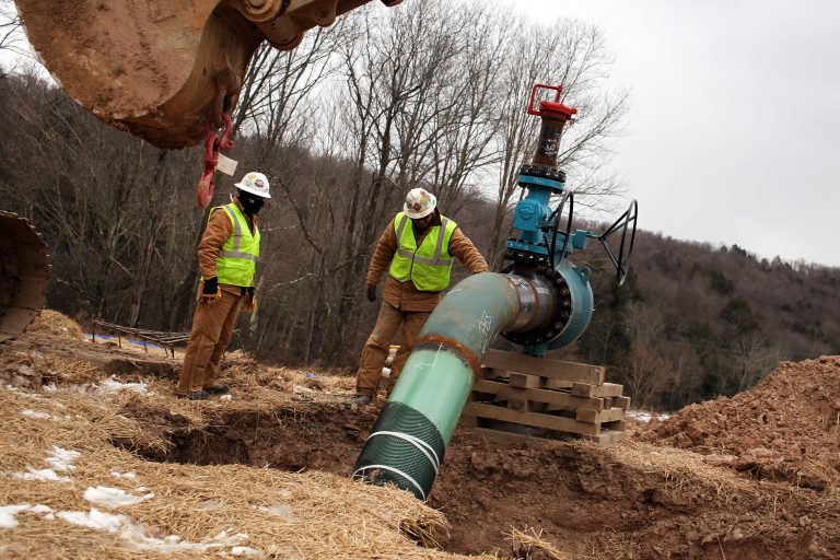 Men work on a natural gas valve at a hydraulic fracturing site in South Montrose, Pa. (Spencer Platt/Getty Images)