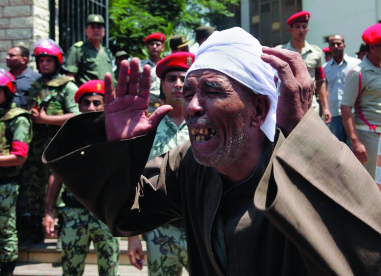 An Egyptian mourns outside the mosque at the funeral of 16 soldiers killed in an attack over the weekend by suspected militants in Sinai in Cairo, Egypt Tuesday Aug. 7, 2012. The military has said that 35 gunmen attacked an Egyptian border post, killing the 16 before commandeering an armored vehicle they later used to try to storm across the border into Israell. (AP Photo/Thomas Hartwell)