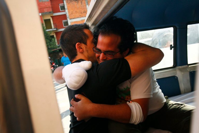 An injured avalanche victim from Israel hugs a friend after boarding an ambulance to head homewards at Ciwec Clinic in Katmandu, Nepal, Saturday, Oct. 18, 2014. Rescue helicopter spotted nine more bodies Saturday on a trekking trail in northern Nepal bringing the death toll to 38 from this weekâs series of snow storms and avalanches in the deadliest week of trekking disaster in Nepal. (AP Photo/Niranjan Shrestha)