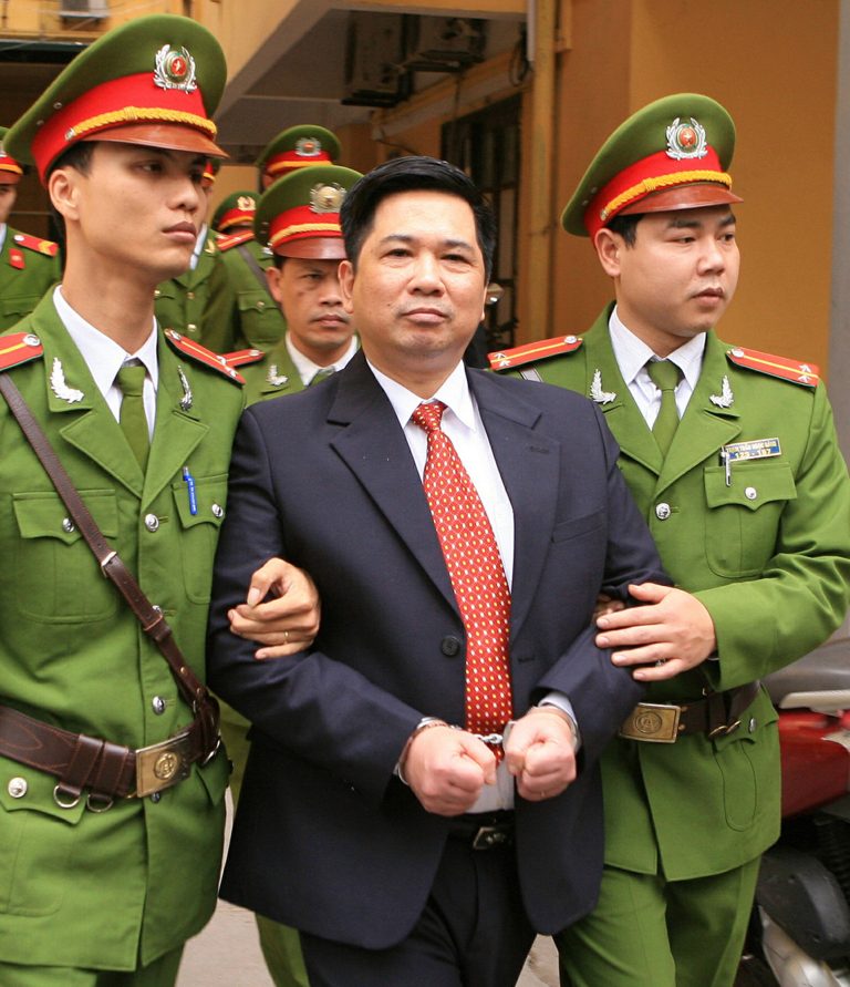 FILE - In this April 4, 2011, file photo dissident lawyer Cu Huy Ha Vu is escorted by police out of a courtroom after being convicted of spreading propaganda against the state and sentenced to seven years in prison and three years of house arrest at the one-day trial in Hanoi, Vietnam. Vu, a prominent Vietnamese dissident whose father was an associate of the nation's founding president Ho Chi Minh, arrived in the U.S. Monday, April 7, 2014, after being released from prison by Vietnam, the State Department said.. (AP Photo/Vietnam News Agency, Thong Nhat, File) NO SALES