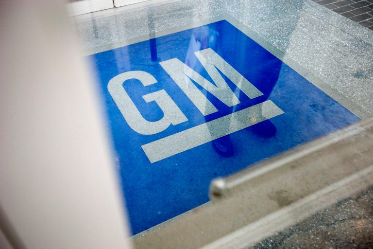 FILE - In this Thursday, Jan. 10, 2013 file photo, the logo for General Motors decorates the entrance at the site of a GM information technology center in Roswell, Ga. GM is recalling 2.6 million small cars worldwide to replace ignition switches that suddenly can slip out of the run position and shut off the engine.  (AP Photo/David Goldman, File)