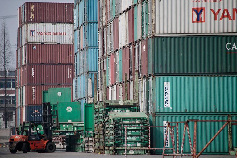 FILE - In this file photo taken March 2, 2011, a forklift arranges the shipping containers near a port in Shanghai. U.S. manufacturers have grown more competitive over the past decade compared with factories in China, Brazil and most of the world's other major economies. So says a new private study issuing a report Friday April 25, 2014, which found that rising wages and higher energy costs have diminished China's long-standing edge over the United States. (AP Photo/Eugene Hoshiko, File)