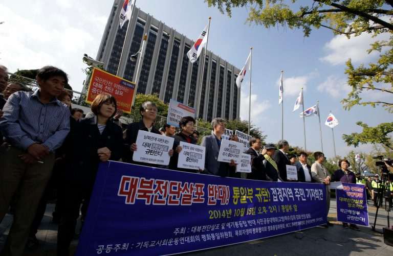 South Korean civic group members and residents in a border area, hold banners demanding protesters to stop sending balloons with anti-Pyongyang propaganda leaflets to North Korea, in front of the government complex in Seoul, South Korea, Wednesday, Oct. 15, 2014. Military generals from North and South Korea met at a border village Wednesday for talks on how to ease animosities between the rival countries following two shooting incidents last week, South Korean media said. The two Koreas traded gunfire Friday after South Korean activists floated balloons carrying the leaflets across the border. The banner read: 
