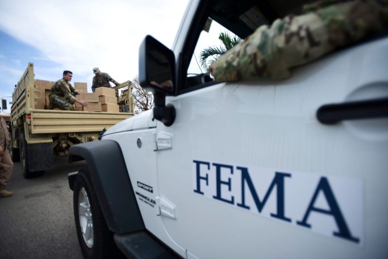 Department of Homeland Security personnel deliver supplies to Santa Ana community residents in the aftermath of Hurricane Maria in Guayama, Puerto Rico, Thursday, Oct. 5, 2017. Even before the storm hit on Sept. 20, Puerto Rico was in dire condition thanks to a decade-long economic recession that had left its infrastructure in a sorry state. (AP Photo/Carlos Giusti)