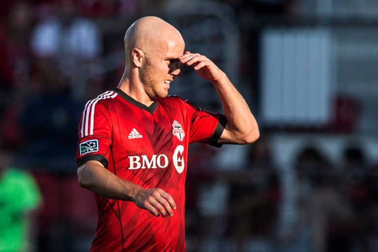 Toronto FC 's Michael Bradley shields his eyes from the sun during first-half MLS soccer game action against D.C. United in Toronto, Saturday, July 5, 2014. (AP Photo/The Canadian Press, Chris Young)