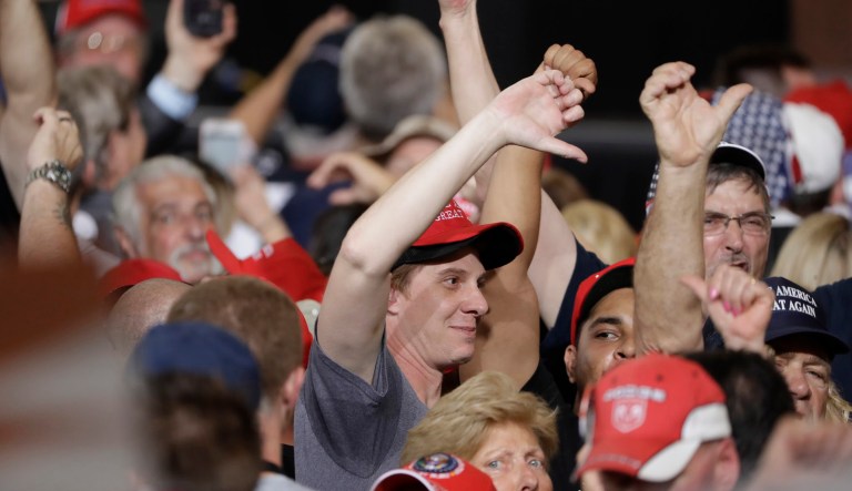 Supporters of President Donald Trump make gestures to the media during a campaign rally. (AP Photo/Chris O'Meara)