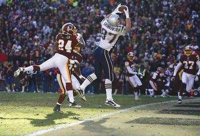 Evan Vucci/AP
The Patriots'Rob Gronkowski caught six passes for 160 yards and two touchdowns Sunday, setting an NFL single-season record for TDs by a tight end with 15.