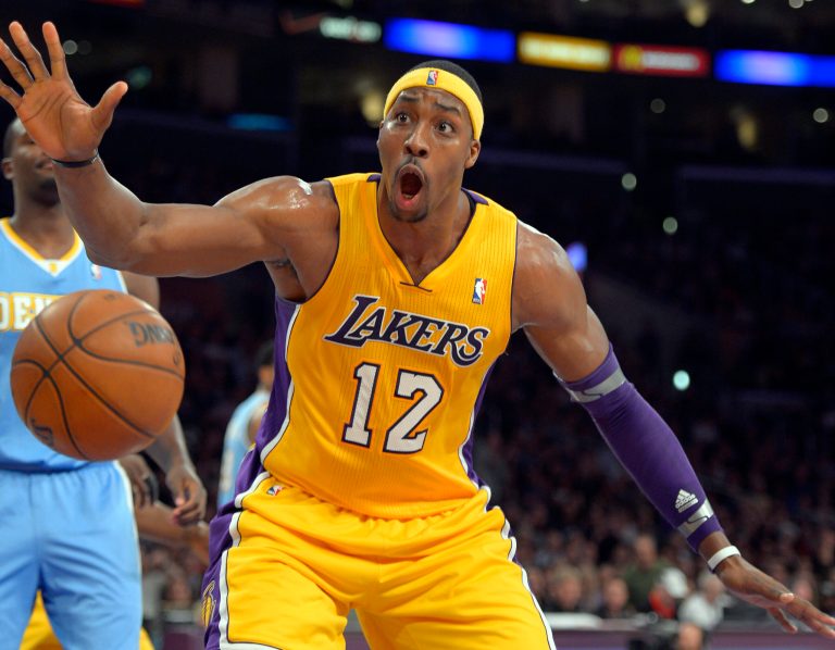   Los Angeles Lakers center Dwight Howard reacts after dunking during the first half of their NBA basketball game against the Denver Nuggets, Friday, Nov. 30, 2012, in Los Angeles. (AP Photo/Mark J. Terrill)  