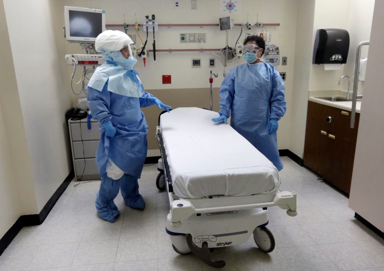 Bellevue Hospital nurses stand in protective suits in an isolation room, in the Emergency Room of the hospital, during a demonstration of procedures for possible Ebola patients on Oct. 8. (AP/Richard Drew)