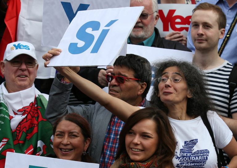 In this photo taken on Tuesday, Sept. 9, 2014, Yes supporters await the arrival of First Minister Alex Salmond to celebrate European citizenship and 