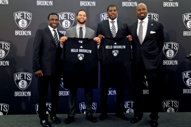 Brooklyn Nets head coach Avery Johnson, from left, players Deron Williams, Joe Johnson, and general manager Billy King pose for photographers during an NBA basketball news conference, Friday, July 13, 2012, in the Brooklyn borough of New York. The Nets introduced their All-Star backcourt of Williams and newly-acquired Johnson in preparation for their first season in Brooklyn. (AP Photo/Mary Altaffer)