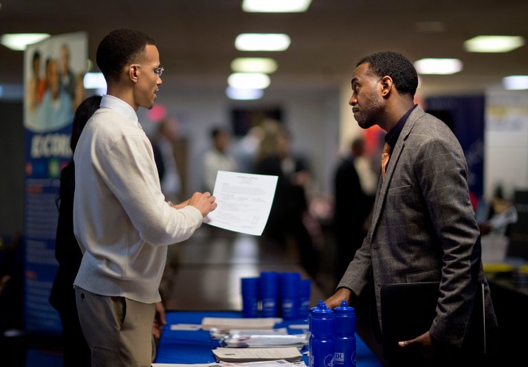 FILE - In this Thursday, Nov. 14, 2013, file photo, retired U.S. Air Force Master Sgt. Thomas Gipson, of Atlanta, right, has his resume looked over by Ralph Brown, a management and program analyst with the Centers for Disease Control and Prevention, during a job fair for veterans at the VFW Post 2681,Marietta, Ga. The Labor Department reports on the number of people who applied for U.S. unemployment benefits last week on Thursday, Dec. 5, 2013. (AP Photo/David Goldman, File)