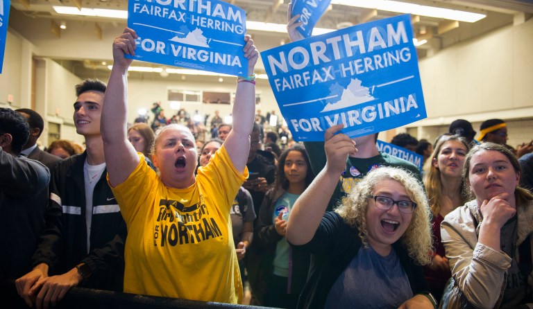 Supporters celebrate news that Democrat Ralph Northam has won the gubernatorial election, while partying at the Northam For Governor election night party at George Mason University in Fairfax, Va., Tuesday, Nov. 7, 2017. (AP Photo/Cliff Owen)