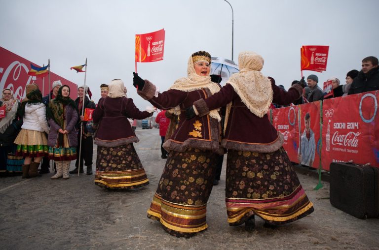 In this photo provided by Olympictorch2014.com, performers dressed in folk costumes dance during a welcome ceremony of the Olympic torch relay in Rostov-on-Don, a city about 1,000 kilometers (600 miles) south of Moscow, Russia, Wednesday, Jan. 22, 2014. The 65,000-kilometer (40,389 mile) Sochi torch relay, which started on Oct. 7, is the longest in Olympic history. The torch has traveled to the North Pole on a Russian nuclear-powered icebreaker and has even been flown into space. (AP Photo/Olympictorch2014.com)
