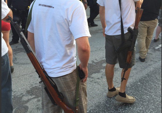 Rally attendees were seen outside the Gilley's South Side Ballroom bearing arms, both literally with firearms and physically, in cut-off shirts. (Courtesy of Vaughn Hillyard, via Twitter)