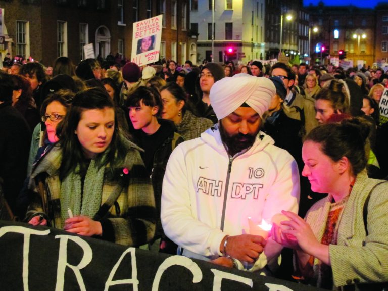 An Indian man and Irish woman light candles as abortion rights protesters march through central Dublin Saturday, Nov. 17, 2012, demanding that Ireland's government create a law defining when abortions can be performed to save a woman's life. Ireland has been shocked by the death of Savita Halappanavar, a 31-year-old Indian dentist who died of blood poisoning after being denied an abortion in a Dublin hospital last month. (AP Photo/Shawn Pogatchnik)