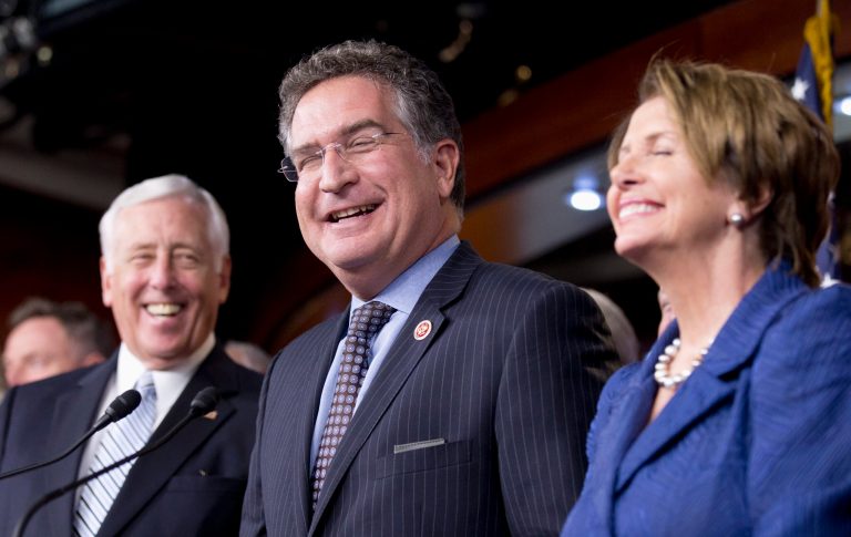   Rep. Joe Garcia, D-Fla., center, House Minority Whip Steny Hoyer, D-Md., left, and House Minority Leader Nancy Pelosi of Calif., laugh in reaction to Garcia's statement that he corrected during a news conference on immigration reform, Wednesday, Oct. 2, 2013, on Capitol Hill in Washington. House Democrats have unveiled an immigration bill that includes a path to citizenship for the 11 million immigrants living here illegally and tightens border security. (AP Photo/Manuel Balce Ceneta)  