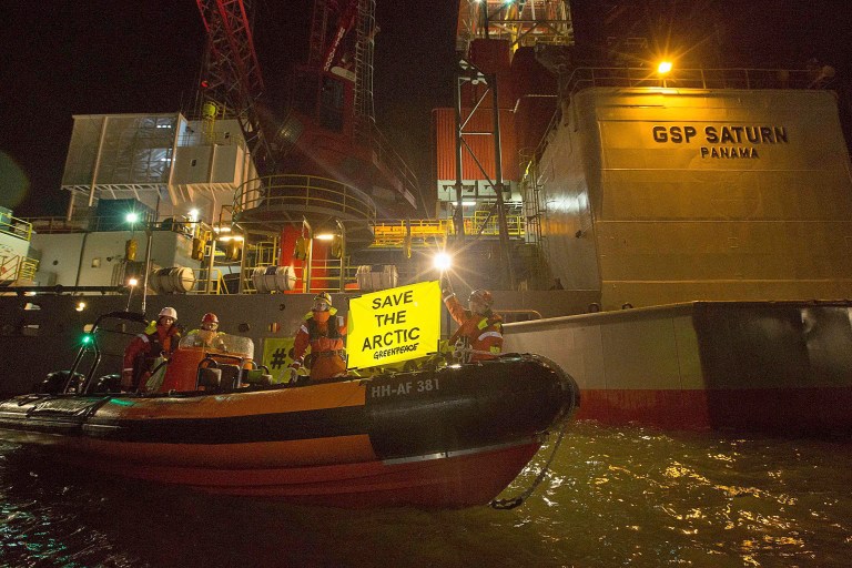 This image made available by environmental organization Greenpeace shows activists boarding a rig contracted by Russia's Gazprom in the port of IJmuiden, Netherlands, on Tuesday, May 27, 2014. Greenpeace said 30 activists in the Dutch port of IJmuiden on Tuesday boarded a rig contracted by Russia's Gazprom to drill in the Pechora Sea. Greenpeace said they were removed after five hours. (AP Photo/Bas Beentjes, Greenpeace)  NO ARCHIVE