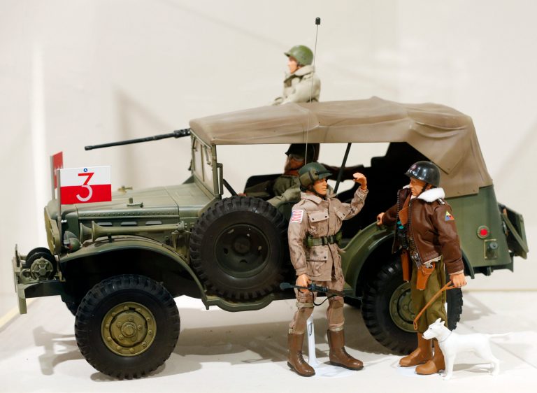 This Jan. 31, 2014 photo shows a Gen. George Patton G.I. Joe action figure, right, and other G.I. Joes in a display at the New York State Military Museum  in Saratoga Springs, N.Y. A half-century after the 12-inch doll was introduced at a New York City toy fair, the iconic action figure is being celebrated by collectors with a display at the military museum, while the toy's maker plans other anniversary events to be announced later this month. (AP Photo/Mike Groll)