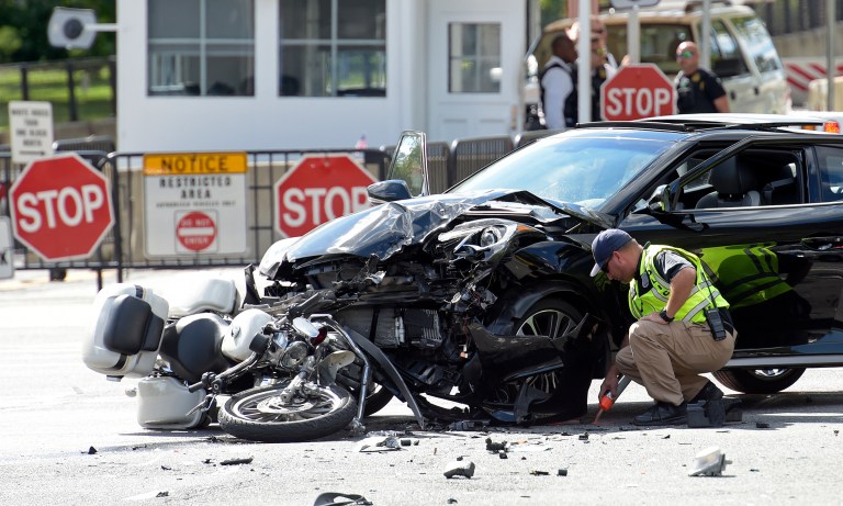 An investigator marks the accident area where a U.S. Secret Service uniformed division motorcycle officer was struck by a car near the White House in Washington, Monday, Sept. 12, 2016. (AP Photo/Susan Walsh)