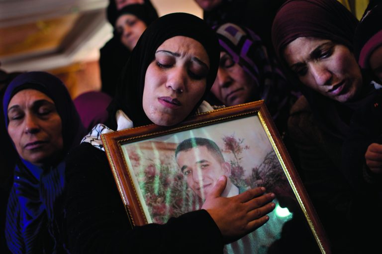 Palestinian women mourn during the funeral of Arafat Jaradat in the West Bank town of Saeer, near Hebron, Monday, Feb. 25, 2013. Thousands have attended the funeral procession of a 30-year-old Palestinian man who died under disputed circumstances in Israeli custody. Palestinian officials say autopsy results show Jaradat was tortured by Israeli interrogators, while Israeli officials say there's no conclusive cause of death yet and that more tests are needed. (AP Photo/Bernat Armangue)