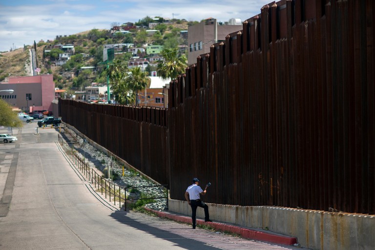 In this April 1, 2017, photo, a man in Nogales, Ariz., talks to his daughter and her mother who are standing on the other side of the border fence in Nogales, Mexico. Homeland Security Secretary John Kelly says arrests of people entering the United States illegally across the Mexican border plummeted in March 2017. That's a signal that fewer people are trying to sneak into the U.S. (AP Photo/Rodrigo Abd)