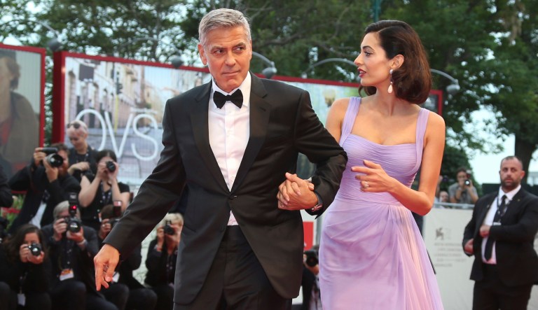 Director George Clooney and his wife Amal Clooney pose for photographers upon arrival at the premiere of the film 'Suburbicon' during the 74th edition of the Venice Film Festival in Venice, Italy, Saturday, Sep. 2, 2017. (Photo by Joel Ryan/Invision/AP)
