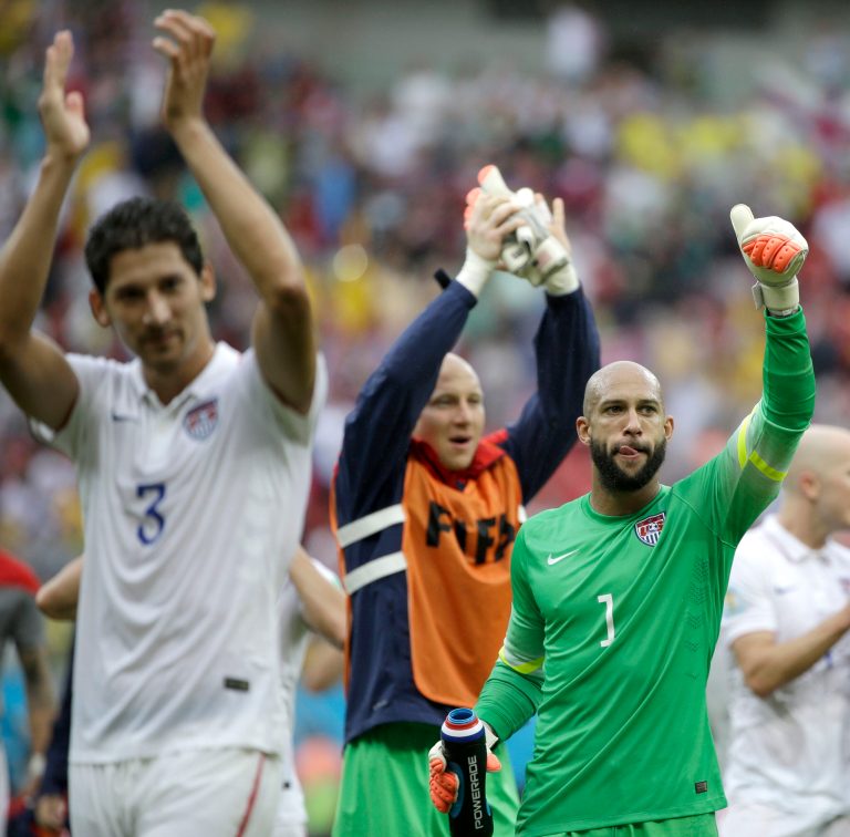 United States' goalkeeper Tim Howard (1) and his teammates celebrate after qualifying for the next World Cup round following their 1-0 loss to Germany during the group G World Cup soccer match between the USA and Germany at the Arena Pernambuco in Recife, Brazil, Thursday, June 26, 2014. (AP Photo/Ricardo Mazalan)