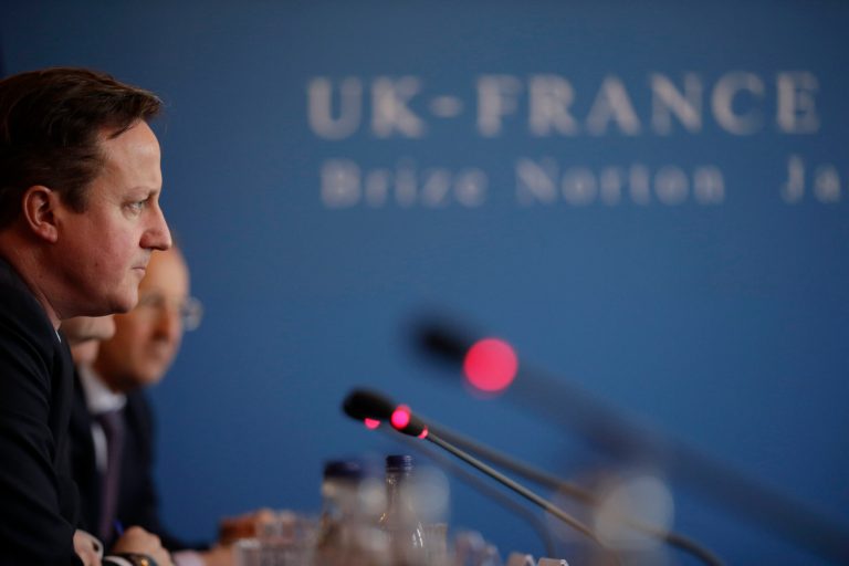 British Prime Minister David Cameron takes part in a plenary meeting with French President Francois Hollande in the Officer's Mess during their one-day summit at the RAF Brize Norton airbase in Brize Norton, England, Friday, Jan. 31, 2014. The one-day summit is expected to cover military cooperation, including talks over armed drones, anti-ship missiles, and underwater mine detectors, as well as a joint Franco-British force of 10,000 soldiers due to be formed in the next few years. (AP Photo/Matt Dunham, Pool)