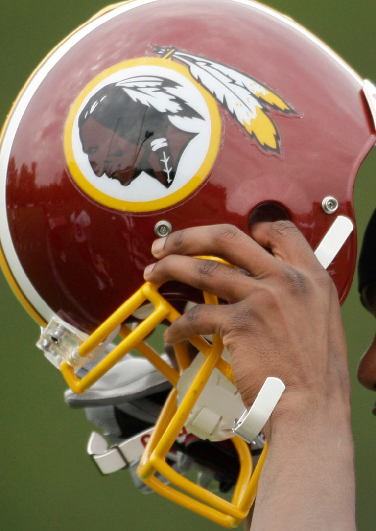 FILE - In this May 1, 2009 file photo, Washington Redskins Marko Mitchell puts his helmet on during their NFL football minicamp practice at their training facility in Ashburn, Va. Half of the U.S. Senate says it's time to change the name of the Washington Redskins. Forty-nine Democratic senators wrote NFL Commissioner Roger Goodell on Thursday, May 22, 2014. They say racism and bigotry do not belong in professional sports.  (AP Photo/Alex Brandon, File)