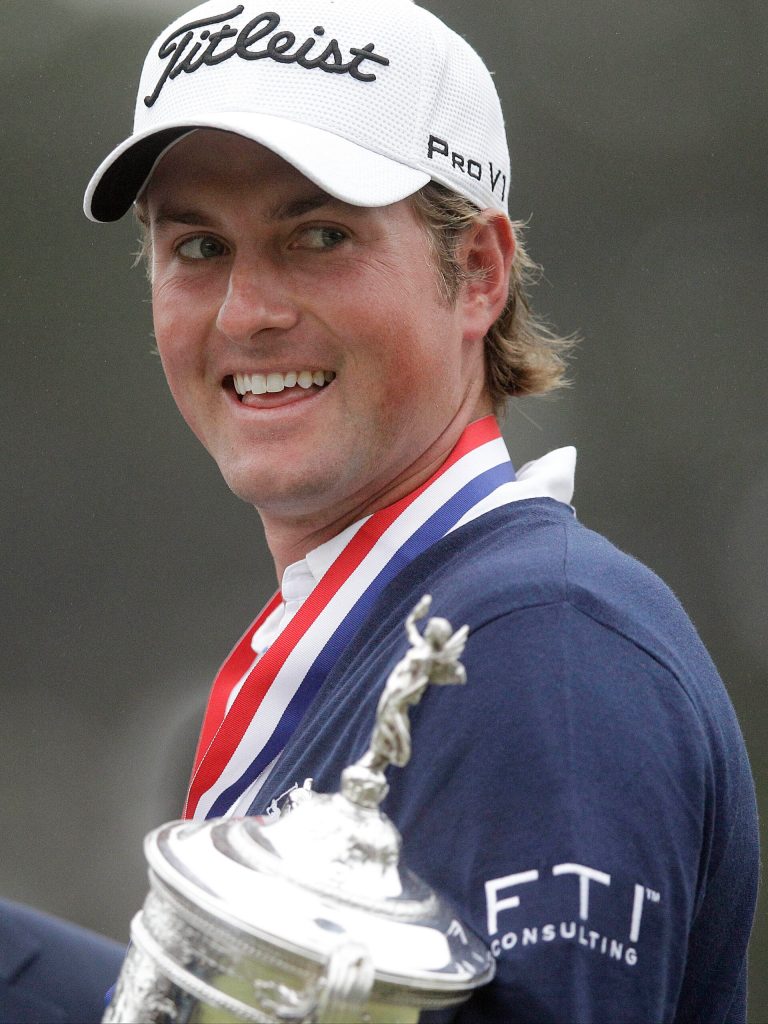   Webb Simpson holds up the championship trophy after the U.S. Open Championship golf tournament Sunday, June 17, 2012, at The Olympic Club in San Francisco. (AP Photo/Charlie Riedel)  